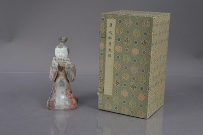 Lot 338 - A Chinese Tang Dynasty style polychrome painted terracotta figure of a kneeling court musician