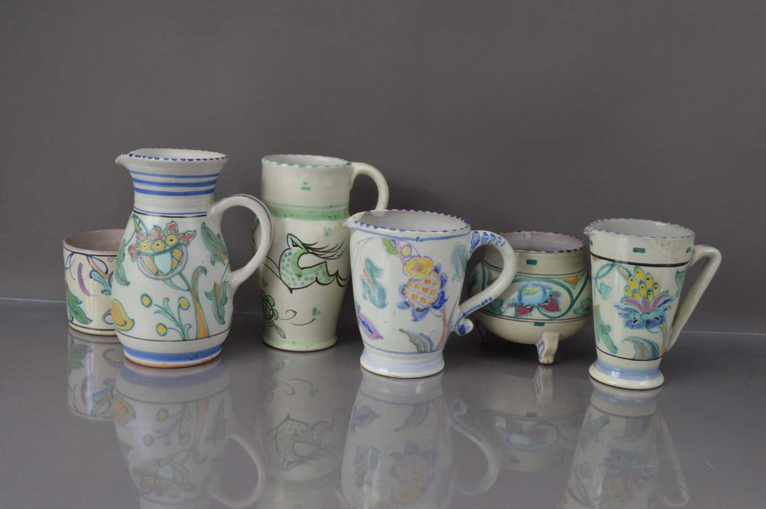 Lot 346 - Six vintage Honiton and other terracotta and floral decorated jugs and vases