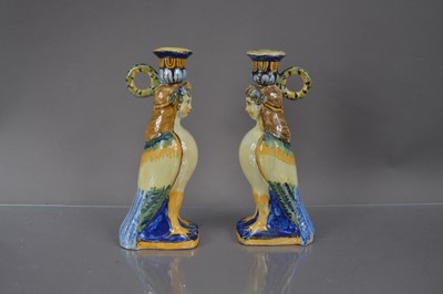 Lot 402 - A pair of faience or majolica neoclassical harpy form candlesticks