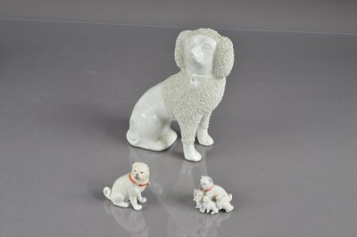 Lot 404 - A late 19th Century Staffordshire poodle and two bisque porcelain pugs