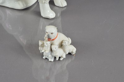 Lot 404 - A late 19th Century Staffordshire poodle and two bisque porcelain pugs