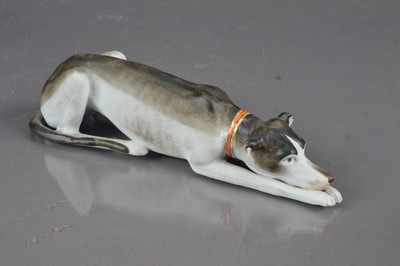 Lot 405 - A late 19th / early 20th Century bisque porcelain whippet or greyhound