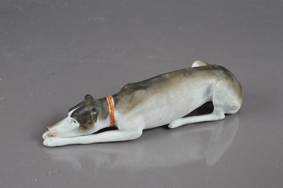 Lot 405 - A late 19th / early 20th Century bisque porcelain whippet or greyhound