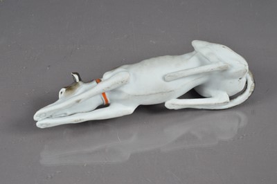 Lot 405 - A late 19th / early 20th Century bisque porcelain whippet or greyhound