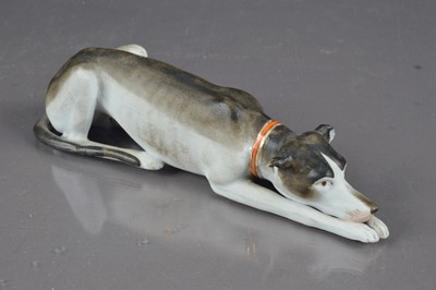 Lot 405 - A late 19th / early 20th Century bisque porcelain whippet or greyhound