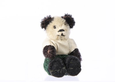 Lot 40 - A post war miniature Schuco Panda dressed teddy bear