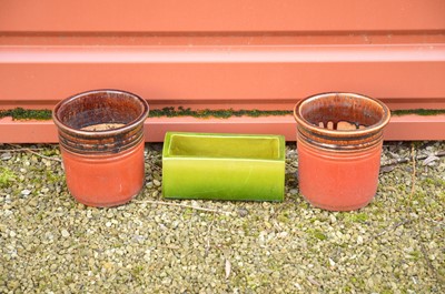 Lot 348 - Two small red treacle glazed plant pots