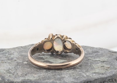 Lot 23 - An Edwadian three stone opal and seed pearl dress ring