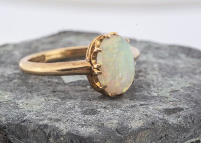 Lot 102 - An Edwardian 18ct yellow gold opal dress ring