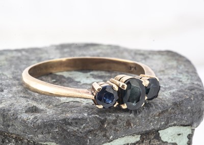 Lot 130 - A 9ct gold three stone sapphire dress ring
