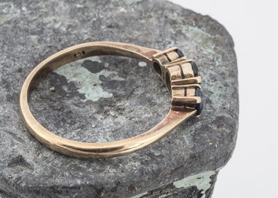 Lot 130 - A 9ct gold three stone sapphire dress ring