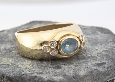 Lot 139 - An aquamarine and diamond 750 marked dress ring