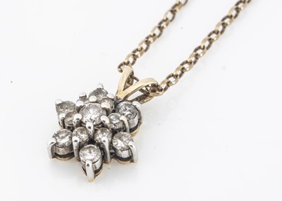 Lot 169 - An 19ct gold and diamond set snowflake pendant