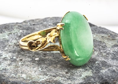Lot 188 - A high carat gold and jade dress ring