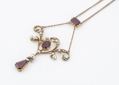 Lot 210 - An Edwardian gold, garnet and seed pearl art nouveau pendant