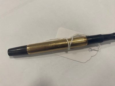 Lot 242 - An Art Deco period brown Bakelite and 9ct gold mounted fountain pen by Ideal