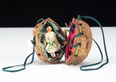 Lot 4 - An 19th century miniature Grodnerthal doll in a walnut shell purse
