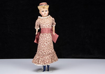 Lot 137 - A German 19th century wax over composition shoulder head dolls with moulded hat
