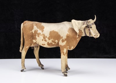 Lot 184 - A late 19th century skin covered cow on wheels