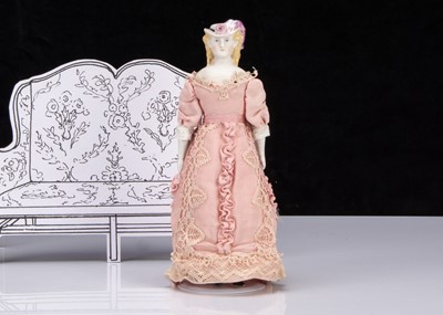 Lot 254 - A rare 19th century small German bisque shoulder-head lady doll with moulded hat