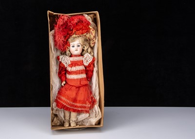 Lot 294 - A German 457 bisque head doll in factory dress and box base