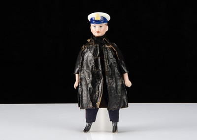 Lot 313 - A German bisque shoulder head dolls’ house Royal Navy officer in oil-cloth coat