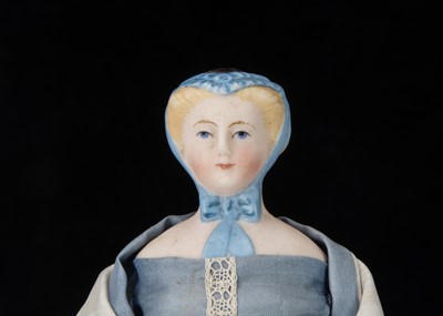 Lot 358 - An unusual small or dolls’ house bisque shoulder head doll with moulded cap