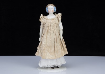 Lot 370 - A late 19th century German bisque shoulder head doll with net snood and ribbons in hair