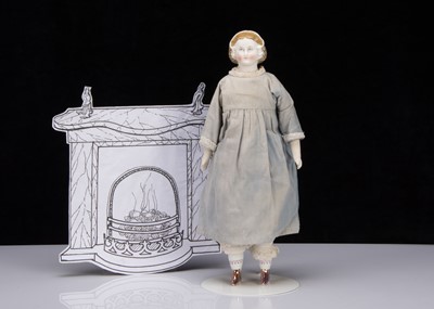 Lot 373 - A late 19th century German bisque shoulder head doll with net snood and ribbons in hair