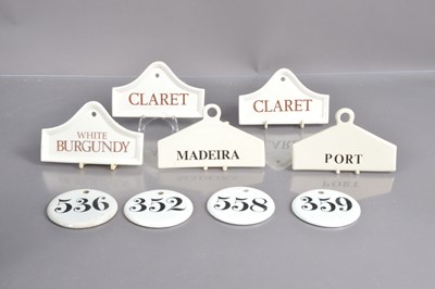Lot 235 - A group of nine porcelain and pottery wine bin labels
