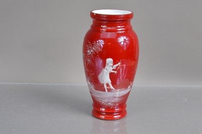 Lot 311 - A cased ruby red on white glass 'Mary Gregory' vase