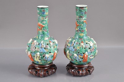 Lot 317 - A pair of 19th Century Chinese famille verte relief moulded and reticulated porcelain bottle vases