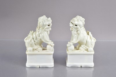 Lot 340 - A pair of antique Chinese blanc-de-chine porcelain foo dogs or guardian lions