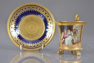 Lot 374 - A porcelain chocolate cup and saucer with gilt and enamel decoration