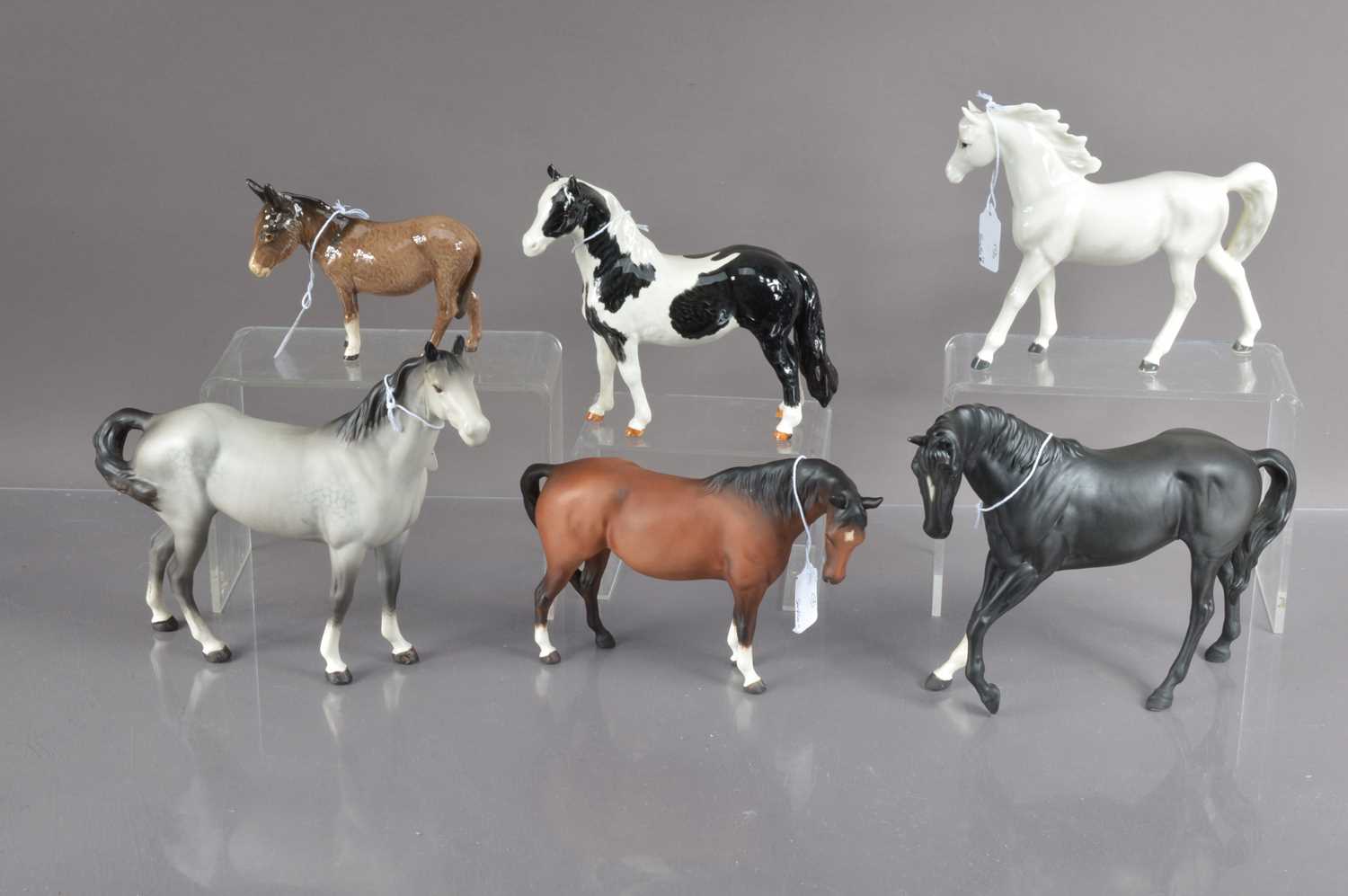 Lot 388 - A group of five Beswick pottery horses and a donkey and one Japanese pottery horse