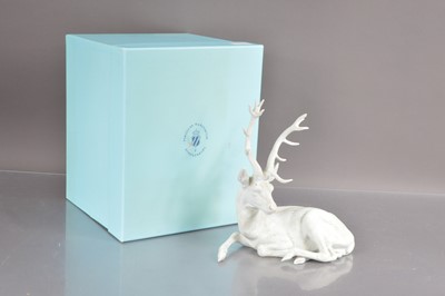 Lot 445 - A Nymphenburg white bisque porcelain figure of a resting stag