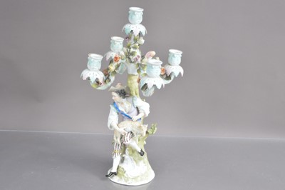 Lot 446 - A late 19th-early 20th Century Sitzendorf German porcelain candelabra modelled with shepherd shearing a sheep