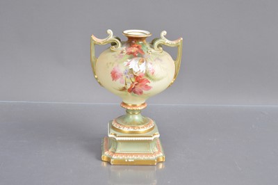 Lot 471 - A Royal Worcester twin handled pedestal urn shape blush ivory vase