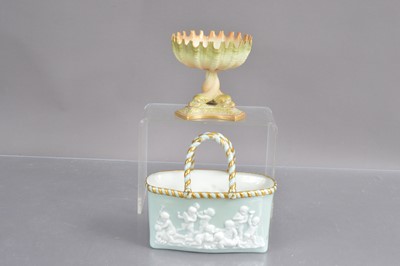 Lot 472 - Two Royal Worcester items including an entwined dolphin crenellated bowl in blush ivory