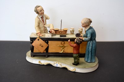 Lot 154 - A Capodimonte porcelain Chemist figural group