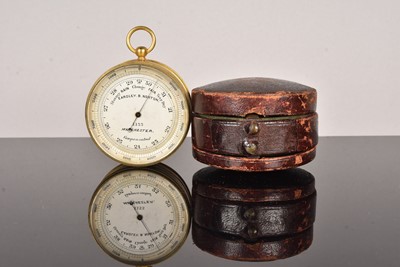 Lot 203 - An Eardley B Norton gilt brass aneroid pocket barometer with altimeter scale and compass