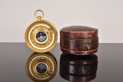 Lot 203 - An Eardley B Norton gilt brass aneroid pocket barometer with altimeter scale and compass