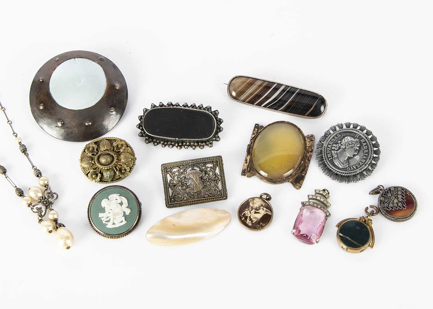 Lot 10 - A collection of hardstone and silver set brooches and pendants