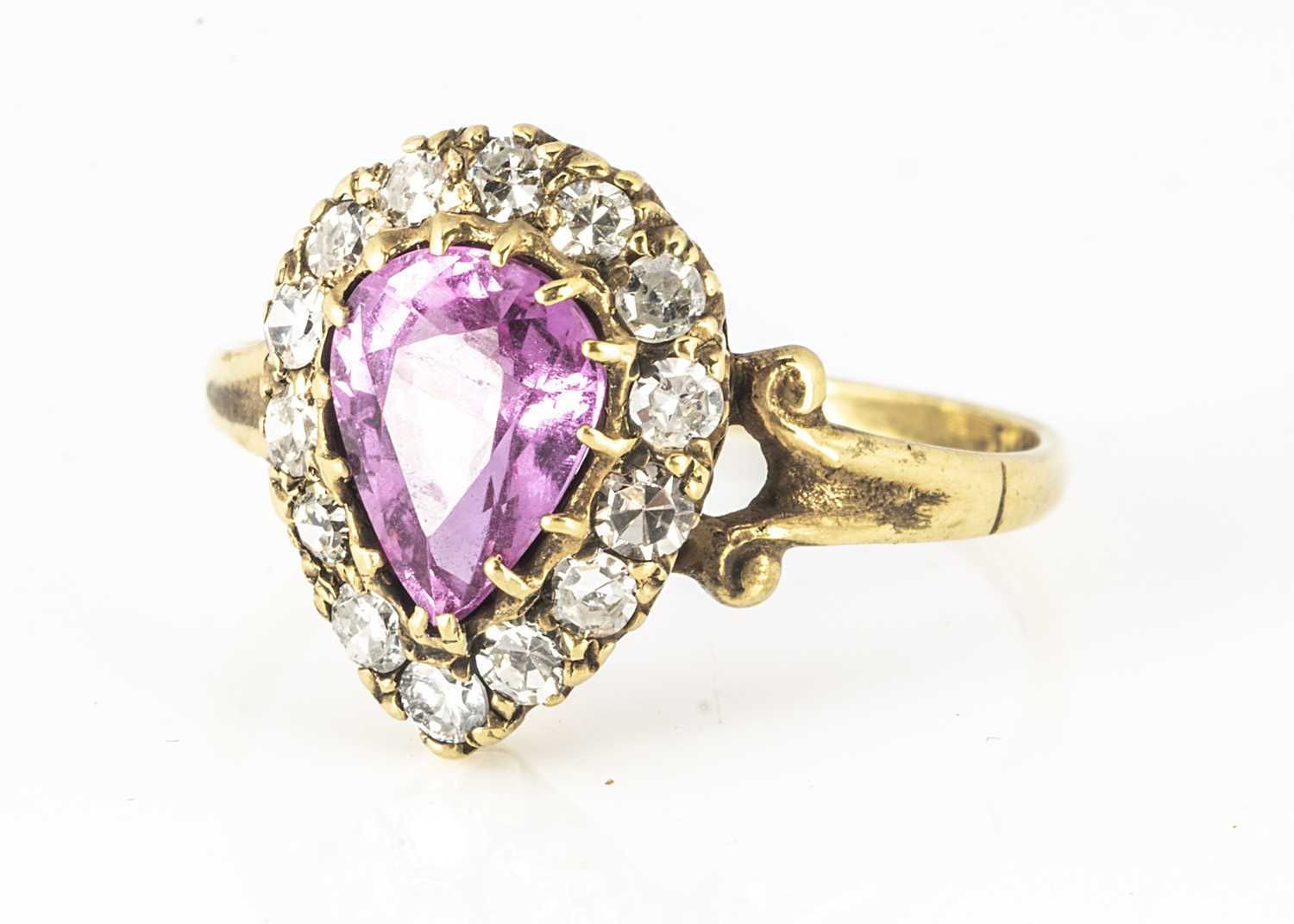 Lot 116 - An 18ct yellow gold pink pear cut sapphire and diamond cluster ring
