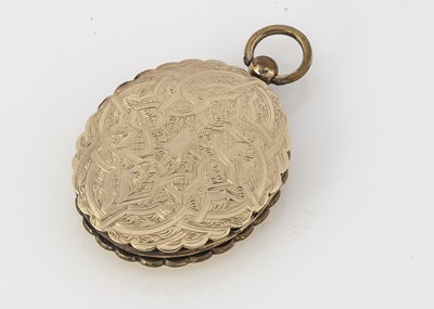 Lot 140 - An oval engraved shaped gold plated locket