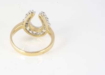 Lot 153 - An 18ct yellow gold diamond horseshoe dress ring
