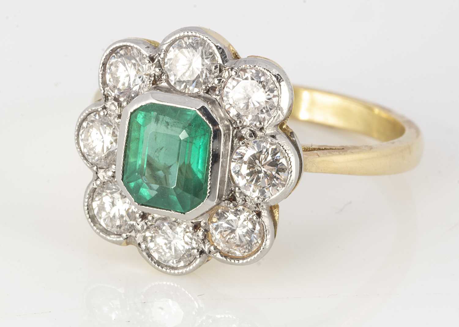 Lot 175 - An 18ct yellow gold emerald and diamond cluster ring
