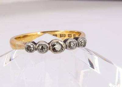 Lot 57 - A 22ct gold wedding band converted to a five stone diamond ring
