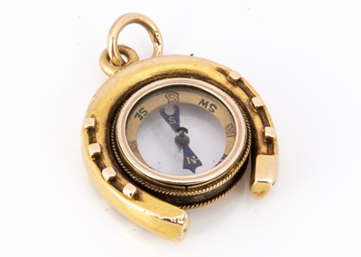 Lot 75 - An Edwardian horseshoe high carat gold compass charm