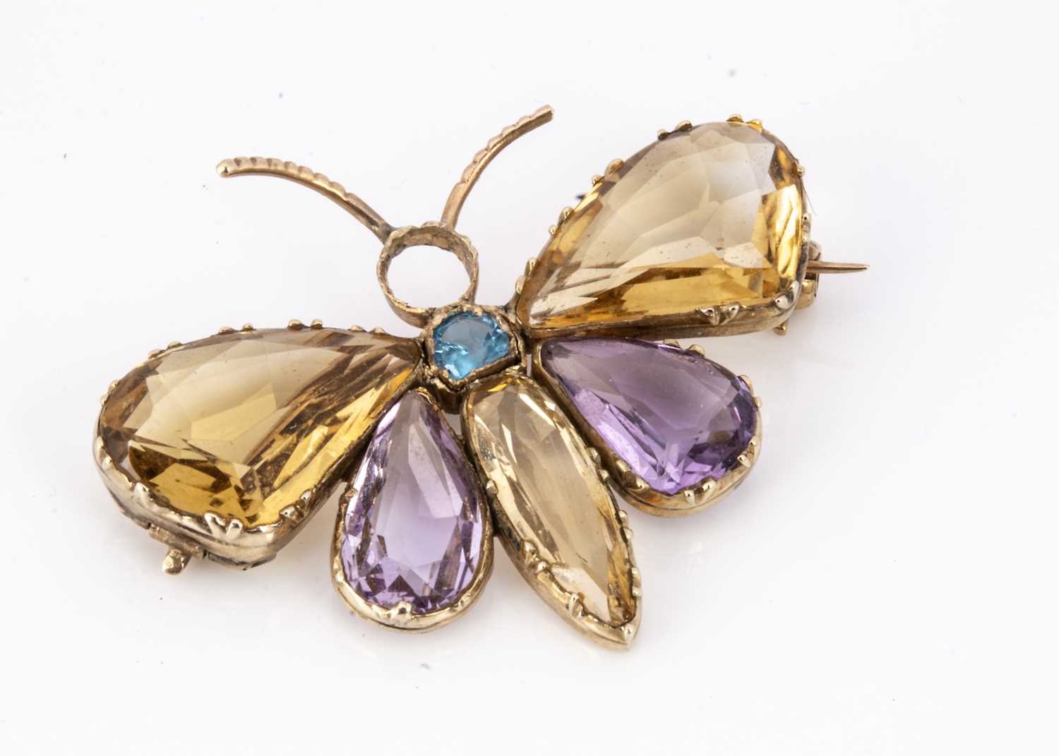 81 - An Edwardian amethyst, Citrine and aqua gem set gold butterfly brooch,